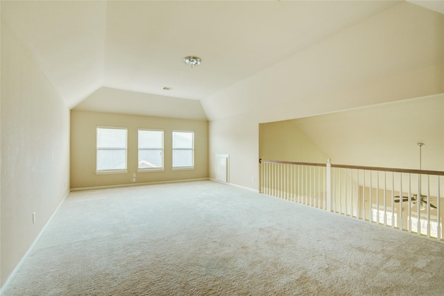 bonus room featuring light colored carpet and vaulted ceiling