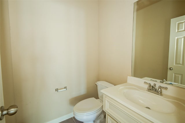 bathroom featuring tile patterned flooring, vanity, and toilet