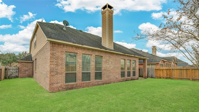 rear view of property featuring a yard