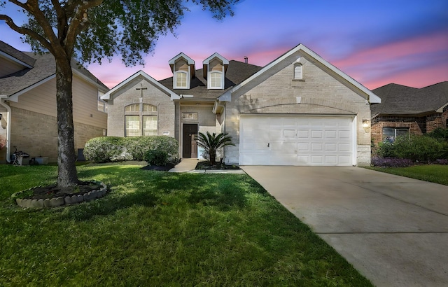 view of front of house with a garage and a lawn