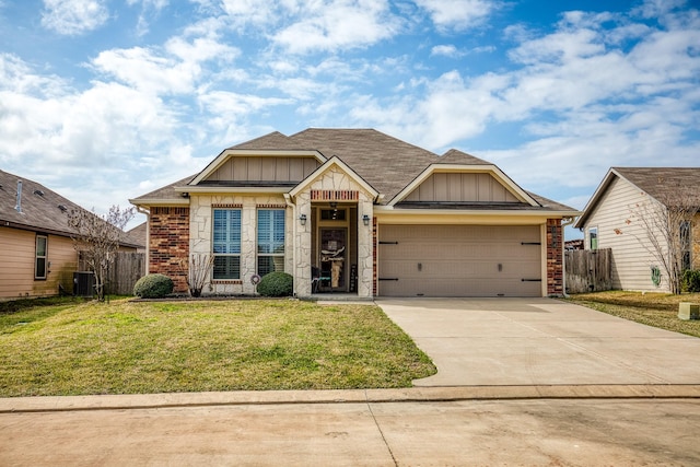 craftsman house featuring central AC unit, a garage, and a front lawn