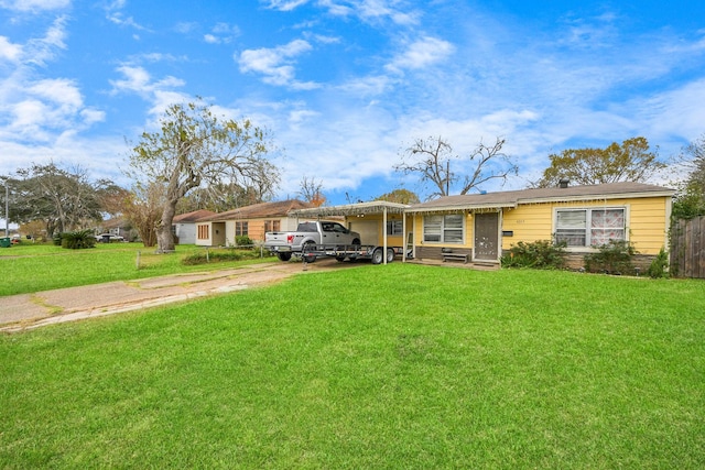 single story home with a front lawn and a carport