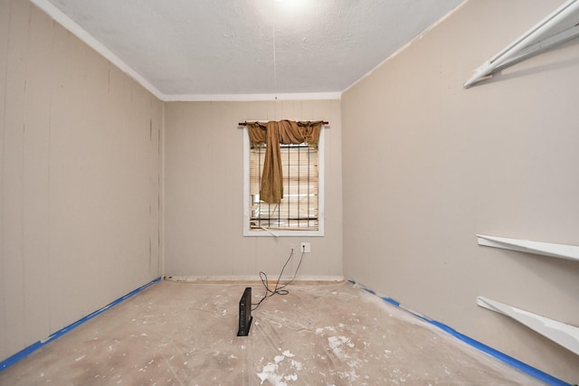 empty room featuring wooden walls and a textured ceiling