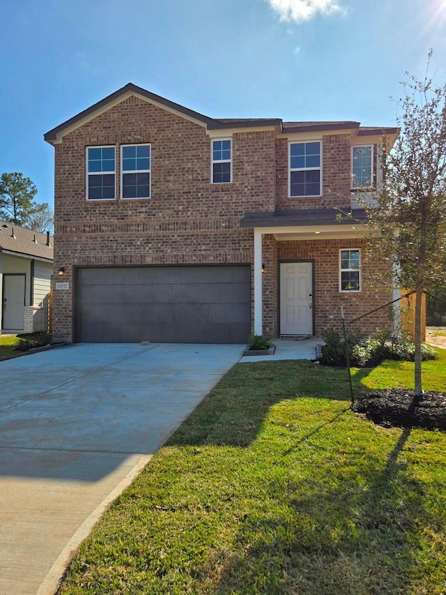 view of front of home with a garage and a front yard