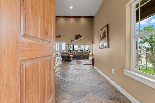 corridor featuring a high ceiling and french doors