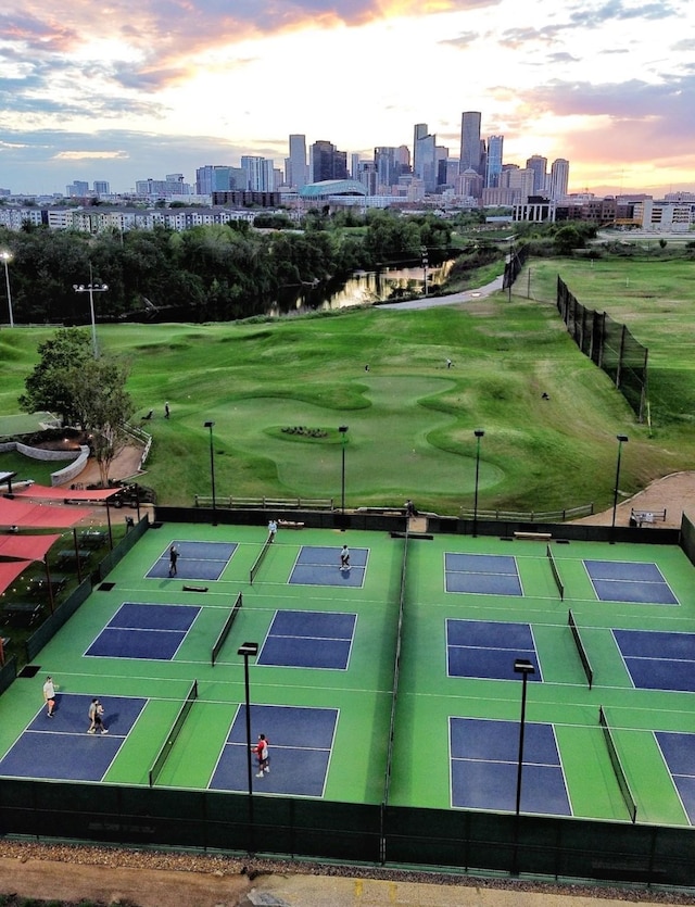 view of home's community with tennis court