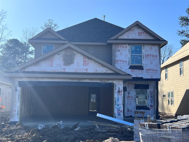 property in mid-construction featuring roof with shingles