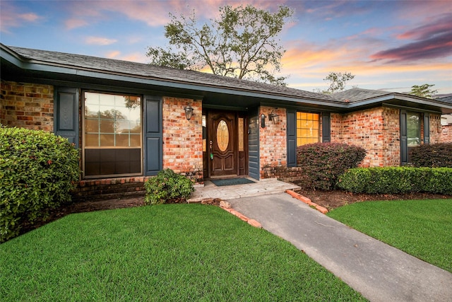 view of front of property with a lawn