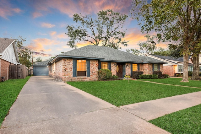 view of front of house with a garage and a yard