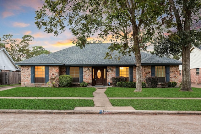 ranch-style house featuring a lawn