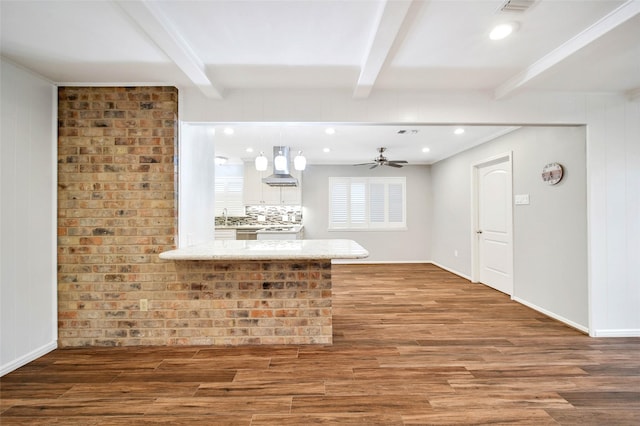 interior space with beamed ceiling, wood-type flooring, and sink