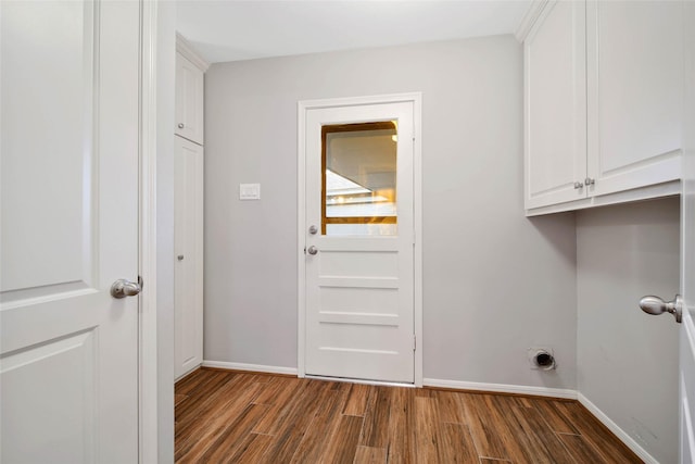 clothes washing area with cabinets, electric dryer hookup, and dark hardwood / wood-style flooring