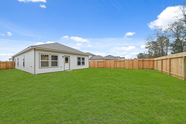 rear view of property with a yard