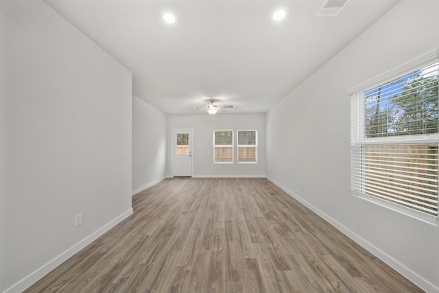 unfurnished room with hardwood / wood-style flooring, plenty of natural light, and ceiling fan