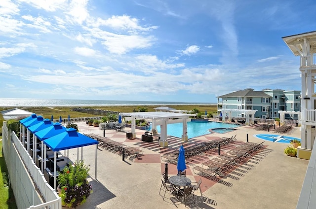 view of pool featuring a pergola, a water view, and a patio