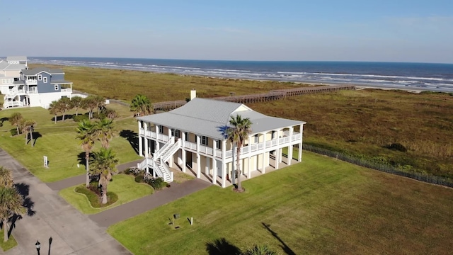 bird's eye view featuring a water view and a beach view