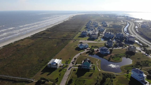 birds eye view of property with a view of the beach and a water view