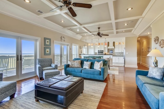 living room featuring beam ceiling, ceiling fan, french doors, coffered ceiling, and hardwood / wood-style floors