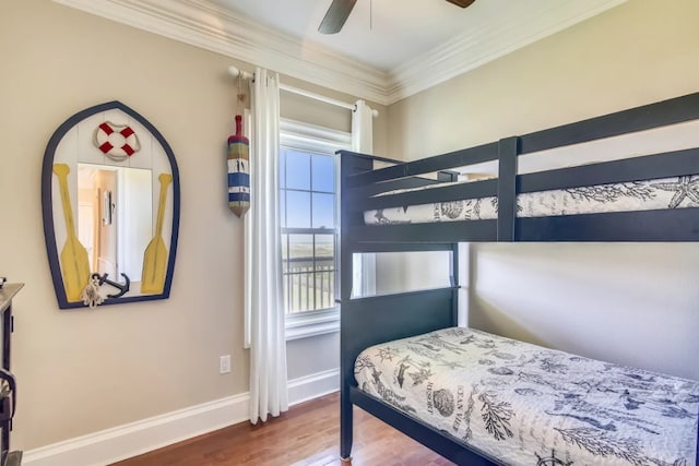 bedroom featuring ceiling fan, wood-type flooring, and ornamental molding