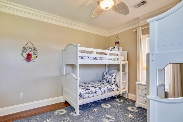 bedroom with ceiling fan, dark hardwood / wood-style floors, and ornamental molding