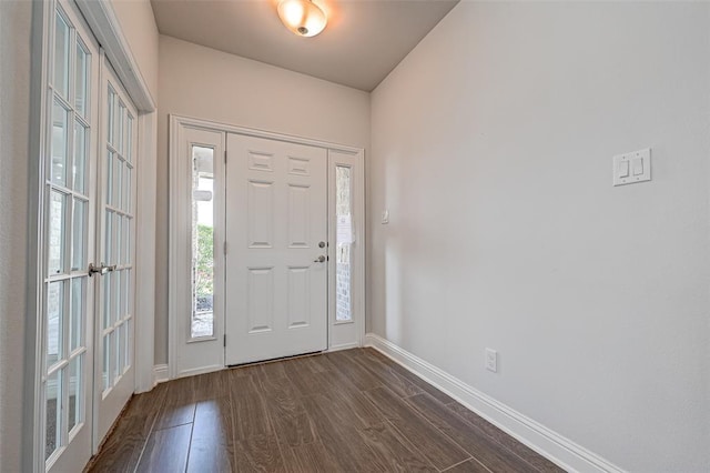 entryway with dark hardwood / wood-style flooring and french doors