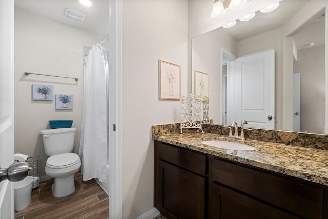 bathroom featuring hardwood / wood-style floors, vanity, and toilet