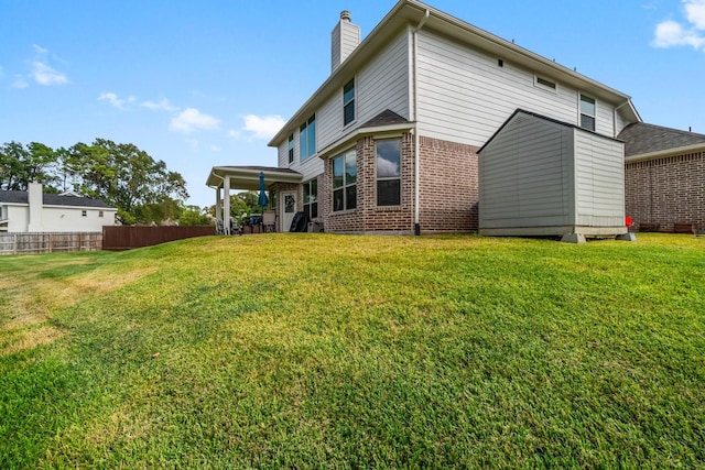 back of house featuring a yard