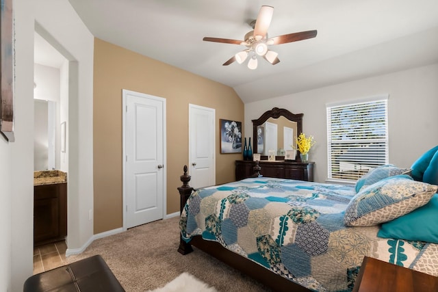 carpeted bedroom with ensuite bath, ceiling fan, and lofted ceiling