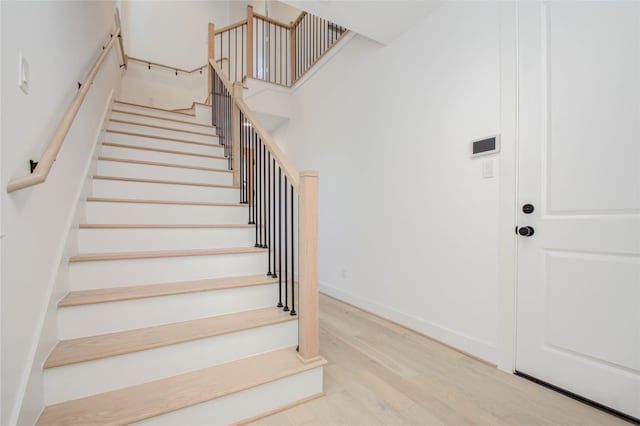 staircase featuring wood-type flooring