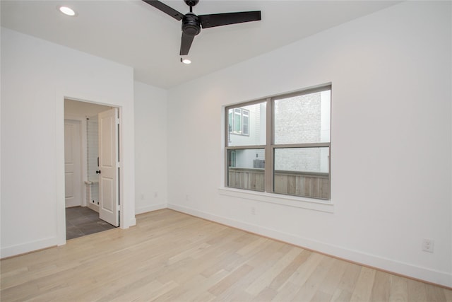 empty room featuring ceiling fan and light wood-type flooring