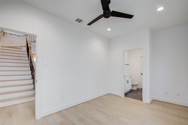 interior space with ensuite bathroom, ceiling fan, and light hardwood / wood-style floors