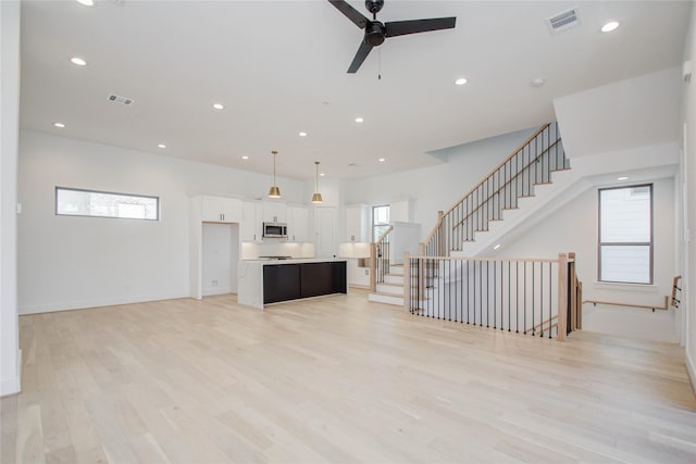 unfurnished living room with light hardwood / wood-style floors and ceiling fan