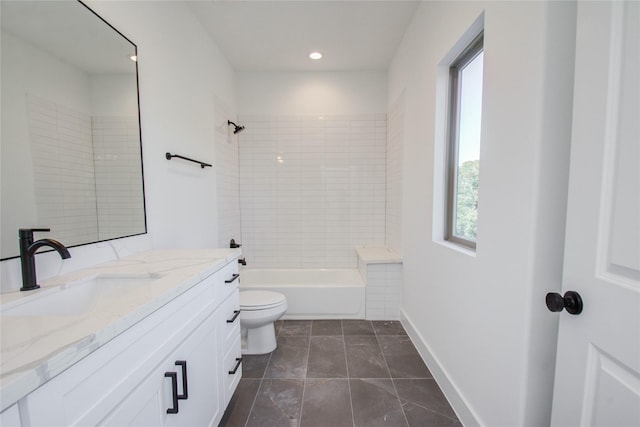 full bathroom featuring tile patterned floors, vanity, tiled shower / bath combo, and toilet