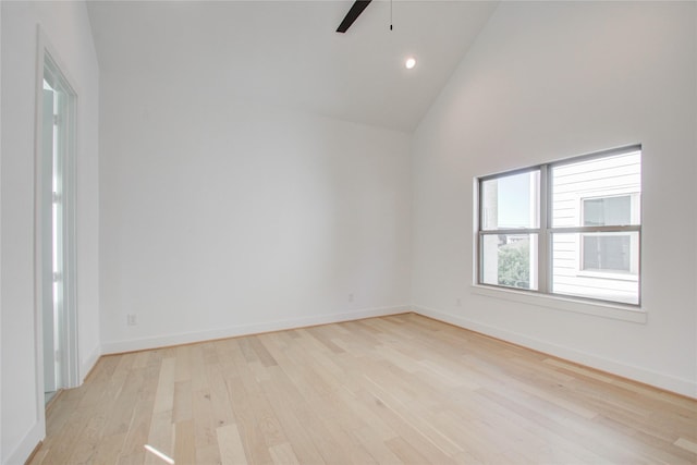 unfurnished room with light hardwood / wood-style flooring, high vaulted ceiling, and ceiling fan