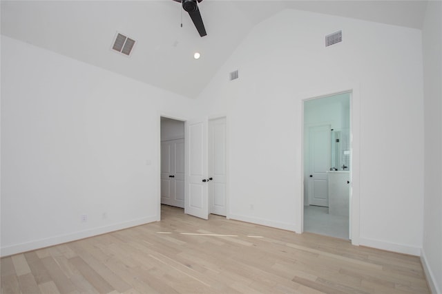 unfurnished bedroom with ensuite bath, high vaulted ceiling, ceiling fan, and light hardwood / wood-style flooring