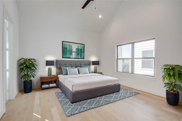 bedroom featuring ceiling fan, high vaulted ceiling, and light hardwood / wood-style floors