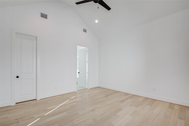 spare room with ceiling fan, light hardwood / wood-style floors, and high vaulted ceiling