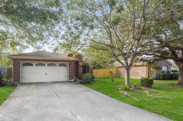 ranch-style home featuring a garage and a front yard