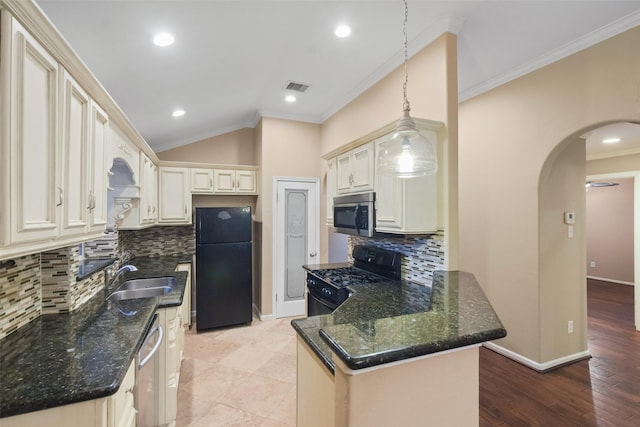 kitchen with dark stone counters, black appliances, sink, hanging light fixtures, and tasteful backsplash