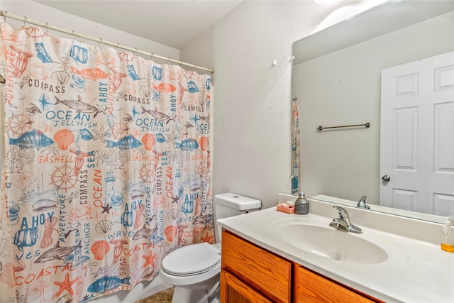 bathroom featuring walk in shower, vanity, and toilet