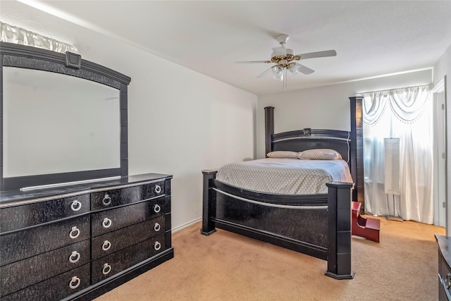 bedroom featuring light carpet and ceiling fan