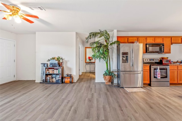 kitchen featuring ceiling fan, light hardwood / wood-style flooring, and stainless steel appliances