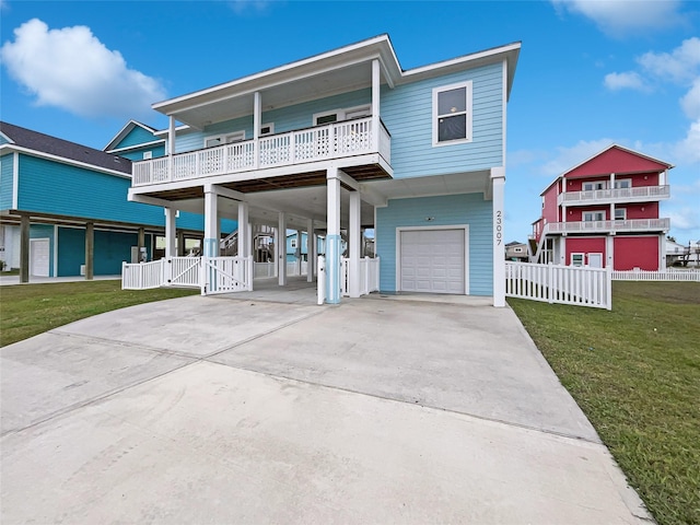 view of front facade with a garage, a front yard, and a carport