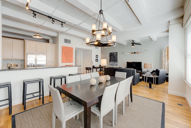 dining space featuring rail lighting, light hardwood / wood-style floors, and ceiling fan with notable chandelier