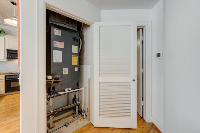 utility room featuring heating unit