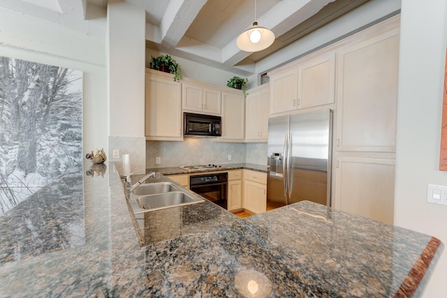 kitchen featuring kitchen peninsula, backsplash, dark stone counters, sink, and black appliances