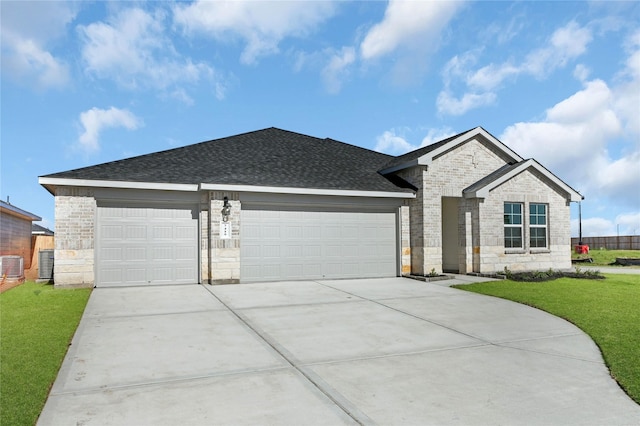 ranch-style house with cooling unit, a garage, and a front lawn