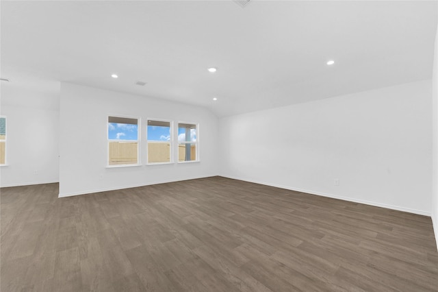 empty room with dark hardwood / wood-style floors and lofted ceiling