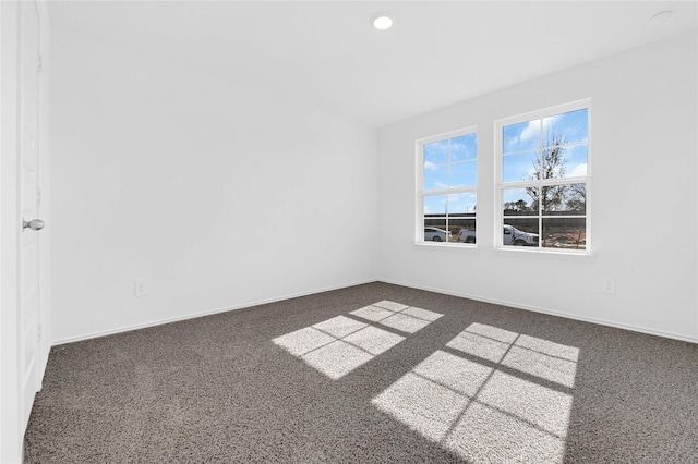 empty room featuring dark colored carpet