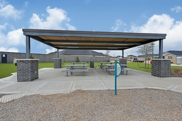 view of community with a lawn and a patio